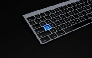 7-Great-Examples-of-How-AI-is-Helping-Small-Businesses-scaledjpg - Onpoint Systems a black keyboard with a blue button on it